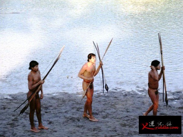 3名最近与外界接触的巴西原始部落成员正手持武器行走，他们中有人在与外界接触中感染了流感病毒。图片来源：巴西印第安人事物管理部门（FUNAI）